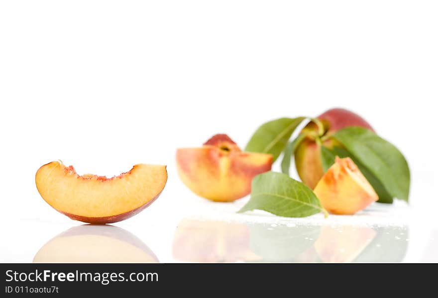 Ripe peach fruit with green leaf isolated on white background. Ripe peach fruit with green leaf isolated on white background