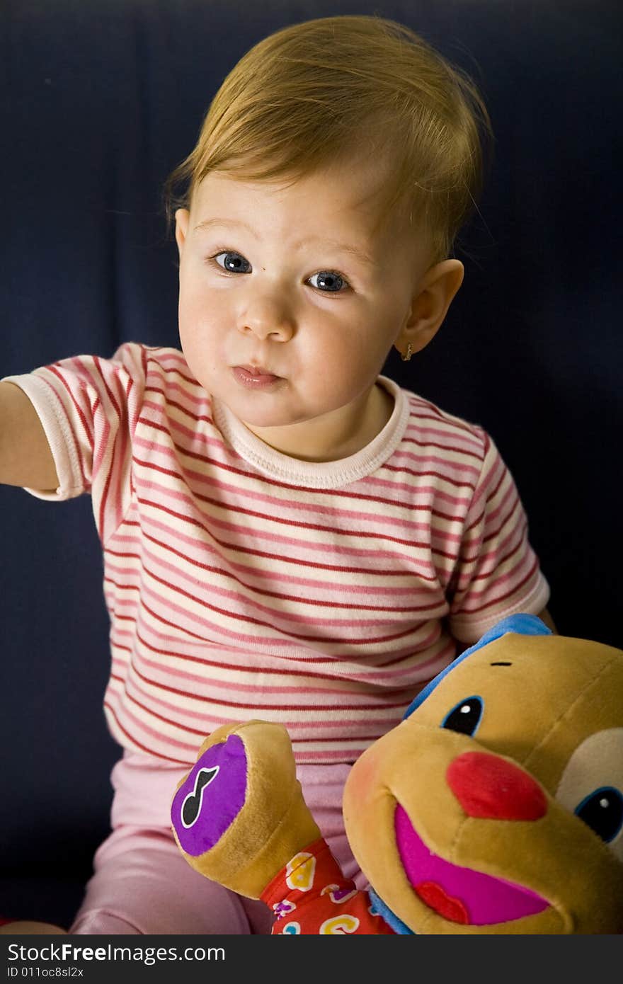 A baby girl with favorite toy