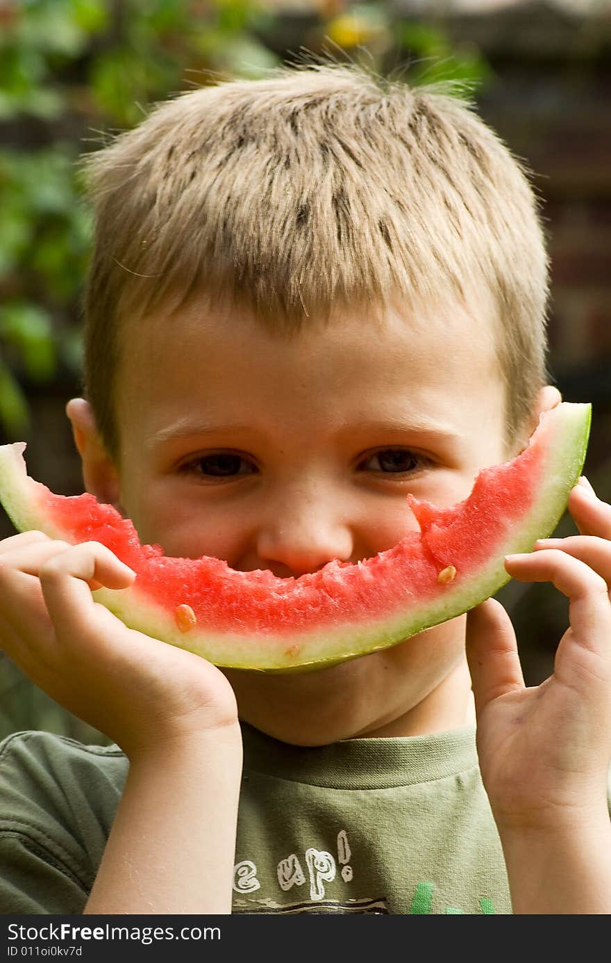 A boy is happy to eat and enjoy health foods like watermellon. A boy is happy to eat and enjoy health foods like watermellon