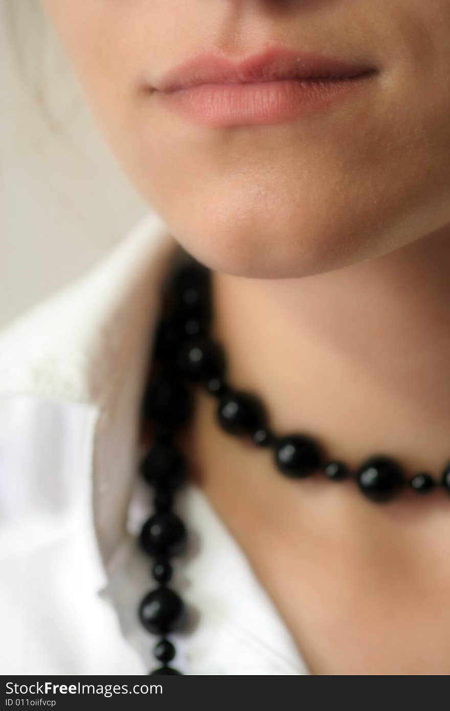 Lips of girl with black pearls