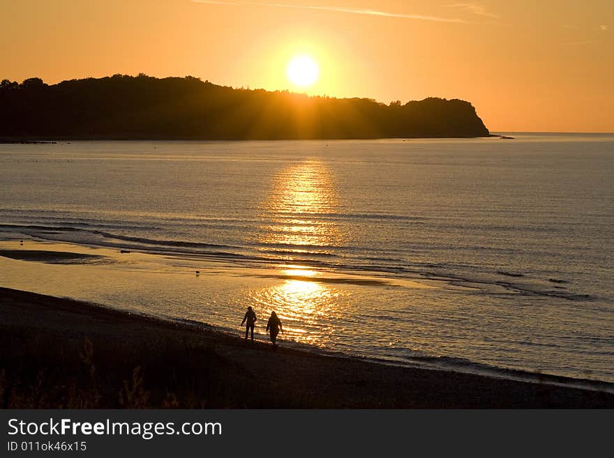 Couple in the sunset by the sea