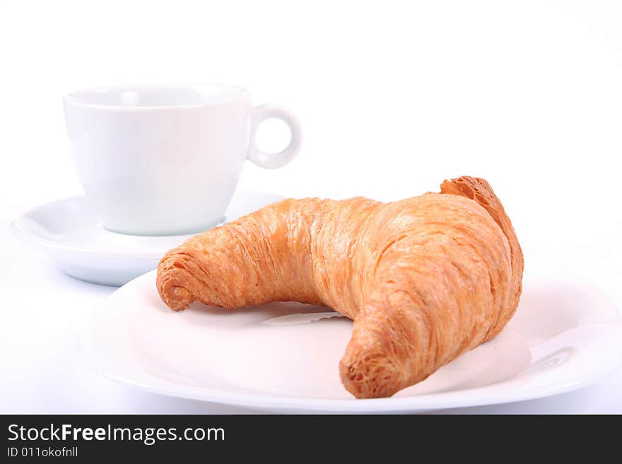 White cup and croissant isolated on white. White cup and croissant isolated on white