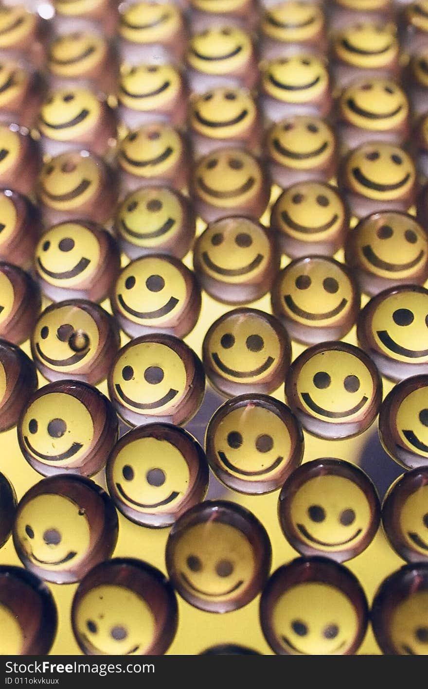 Photo of smiley faces in glass marbles.