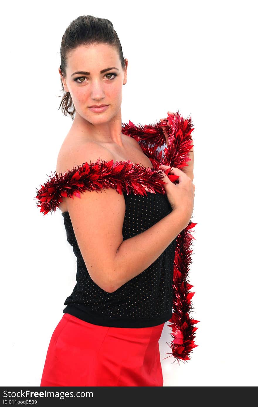 Portrait of a beautiful young brunette woman with tinsel for Christmas. Portrait of a beautiful young brunette woman with tinsel for Christmas.