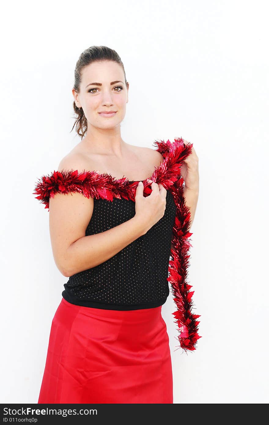 Portrait of a beautiful young brunette woman with tinsel for Christmas. Portrait of a beautiful young brunette woman with tinsel for Christmas.