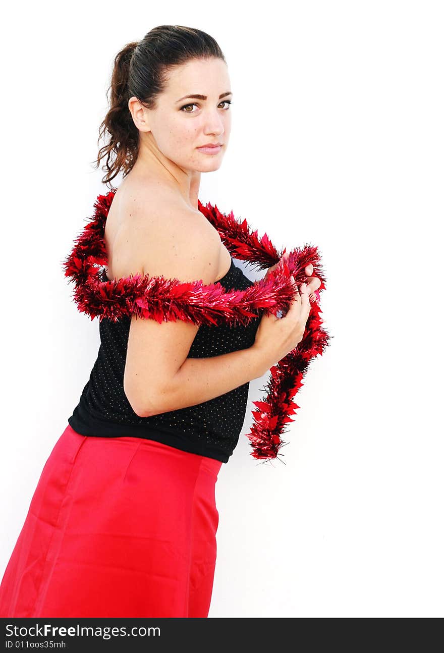 Portrait of a beautiful young brunette woman with tinsel for Christmas. Portrait of a beautiful young brunette woman with tinsel for Christmas.