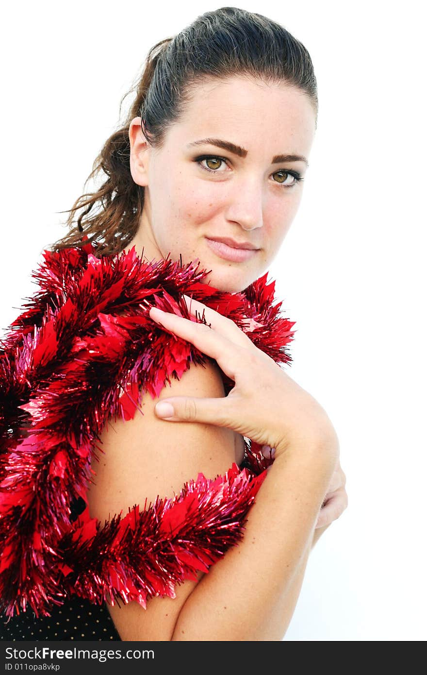 Portrait of a beautiful young brunette woman with tinsel for Christmas. Portrait of a beautiful young brunette woman with tinsel for Christmas.