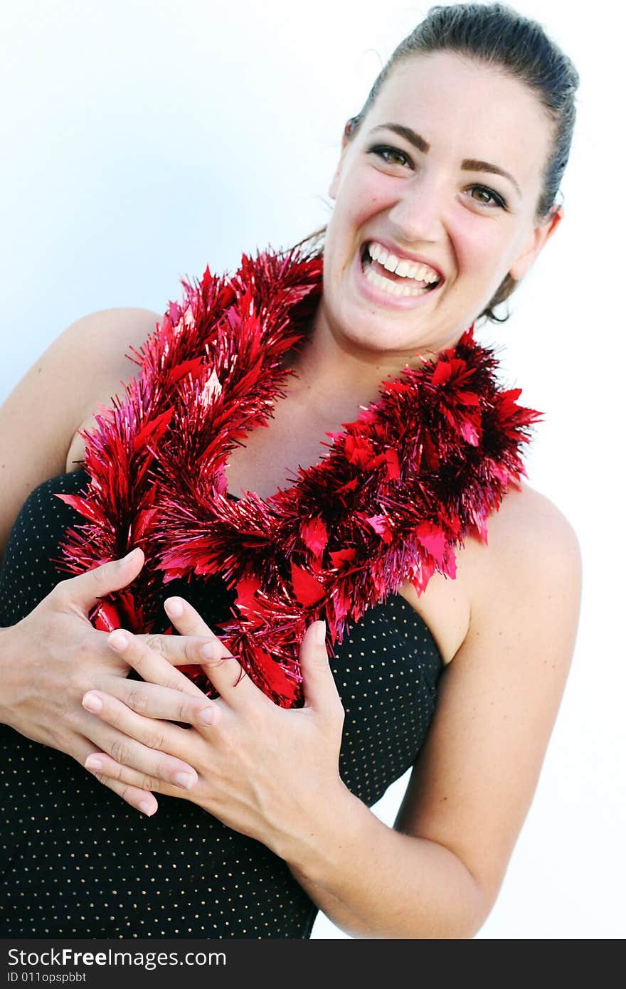 Portrait of a beautiful young brunette woman with tinsel for Christmas - isolated. Portrait of a beautiful young brunette woman with tinsel for Christmas - isolated.