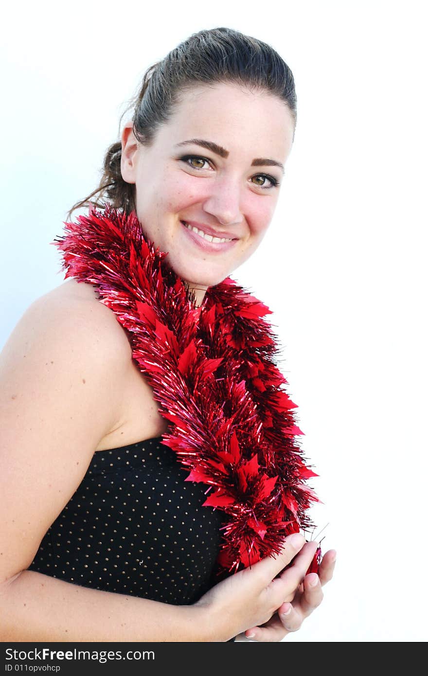 Portrait of a beautiful young brunette woman with tinsel for Christmas - isolated. Portrait of a beautiful young brunette woman with tinsel for Christmas - isolated.