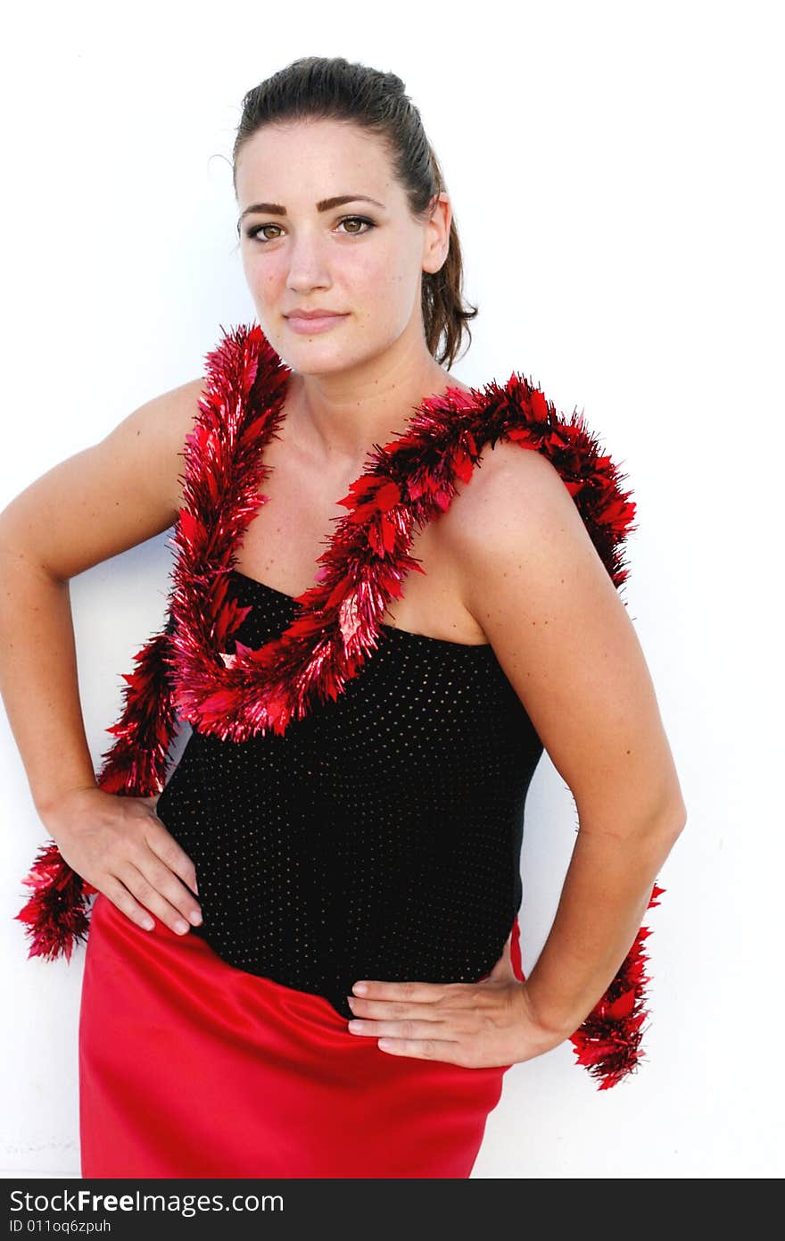 Portrait of a beautiful young brunette woman with tinsel for Christmas - isolated. Portrait of a beautiful young brunette woman with tinsel for Christmas - isolated.