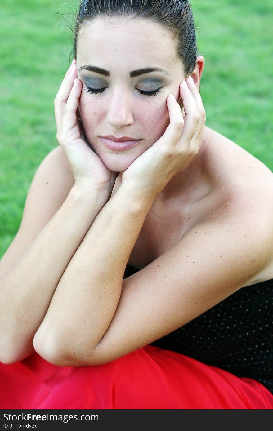 Portrait of a beautiful young brunette woman with her eyes closed.