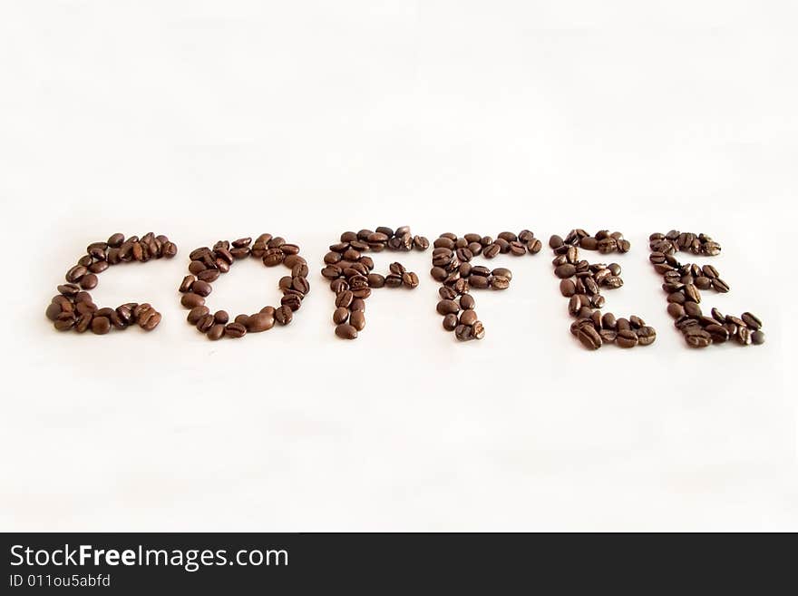 The word coffe made with coffee beans and isolated on a white background. The word coffe made with coffee beans and isolated on a white background