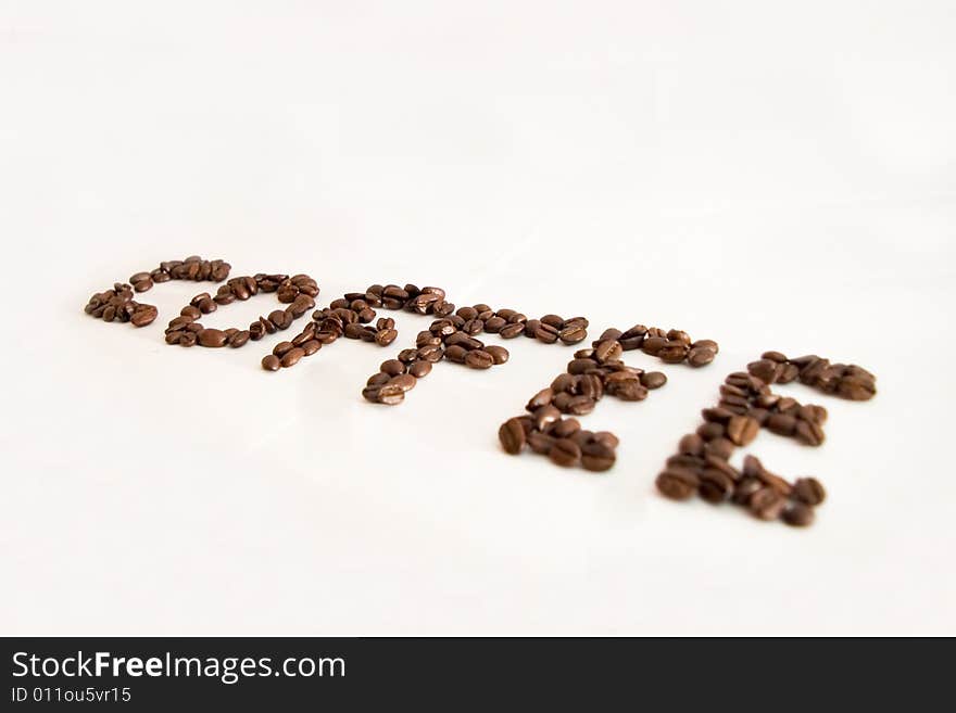 The word coffe made with coffee beans and isolated on a white background