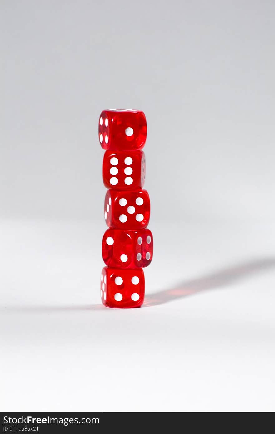 A tower of four red dices isolated on a white background