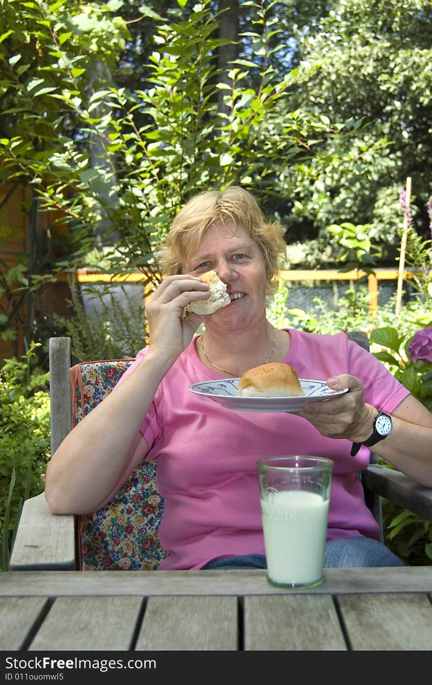 Elderly woman is eating