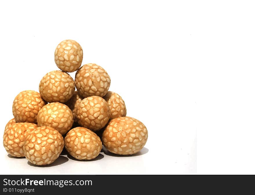 Bowl of Asian rice and sesame crackers against white background. Bowl of Asian rice and sesame crackers against white background