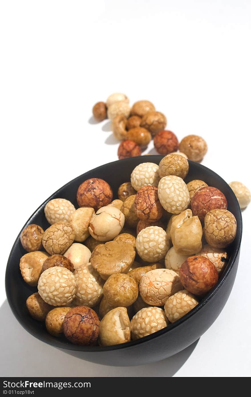 Bowl of Asian rice and sesame crackers against white background. Bowl of Asian rice and sesame crackers against white background