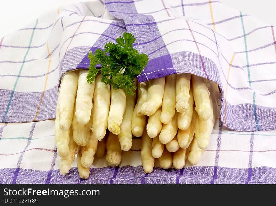 Fresh asparagus wrapped in a kitchen towel. Fresh asparagus wrapped in a kitchen towel