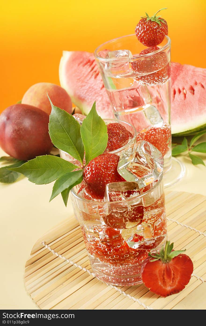 Fresh iced drink (water) served with strawberries. Fresh iced drink (water) served with strawberries