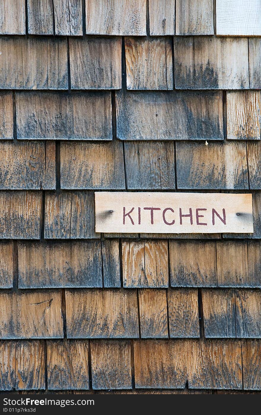 Kitchen sign on shingle cabin wall