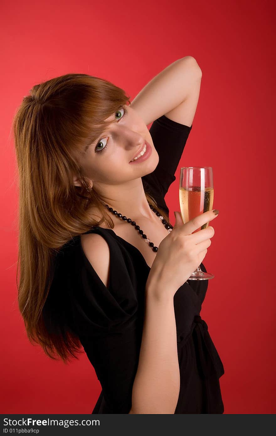 Smiling girl with champagne glass isolated on red background