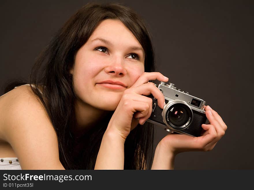 Romantic girl with retro camera isolated in studio