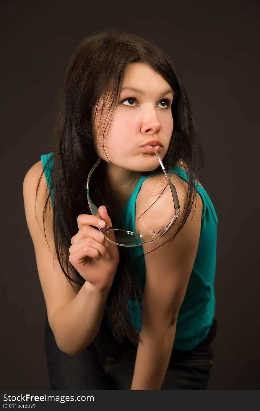 Young girl with fashion sunglasses isolated on black background