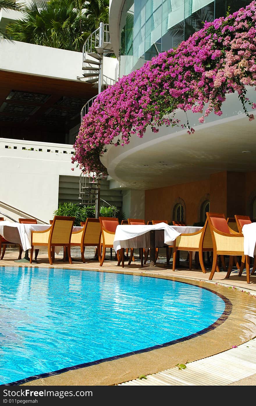 Tables and chairs near the resort's pool. Tables and chairs near the resort's pool