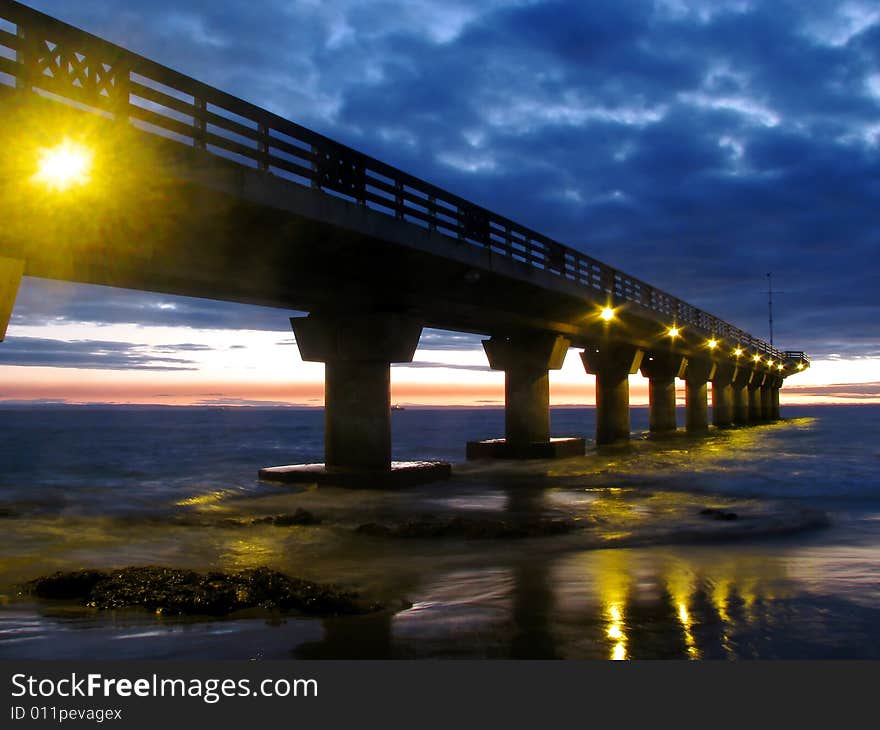 Low light photo of a pier at sunrise. Low light photo of a pier at sunrise