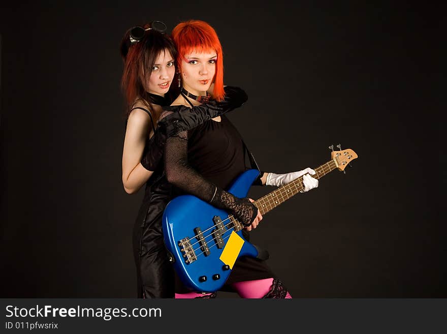 Two rock girls hugging isolated on black background