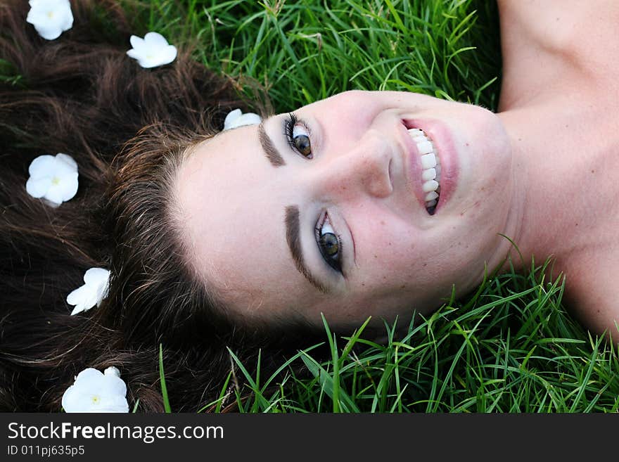 Portrait of a beautiful young woman with flowers in her hair.