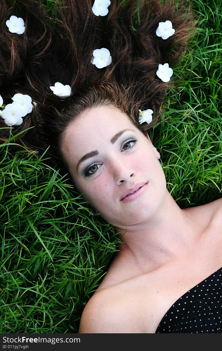 Portrait of a beautiful young woman with flowers in her hair.