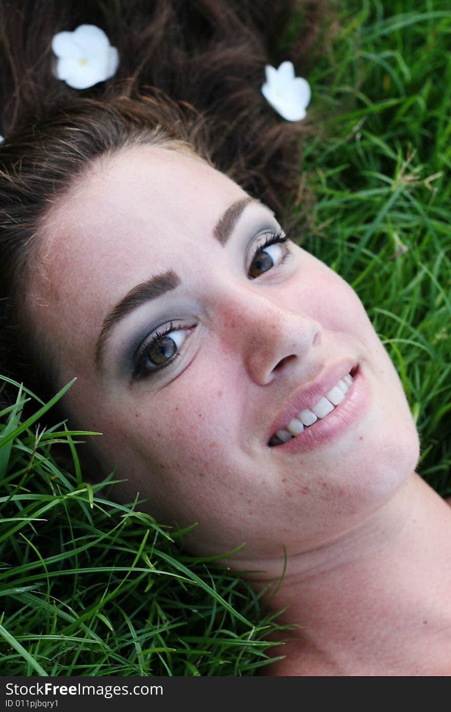 Portrait of a beautiful young woman with flowers in her hair.