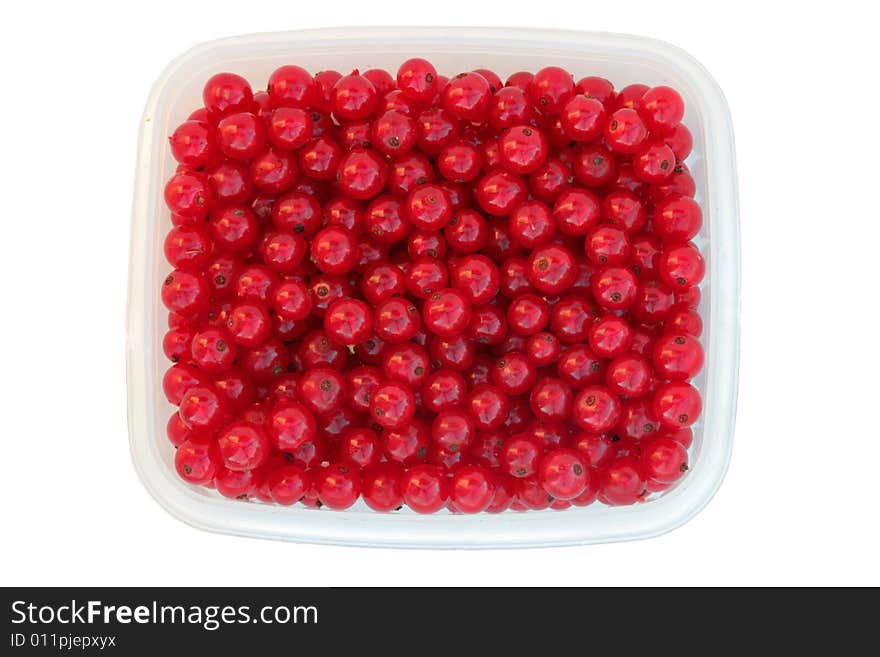 Red currant in transparent сontainer isolated on a white. Red currant in transparent сontainer isolated on a white.