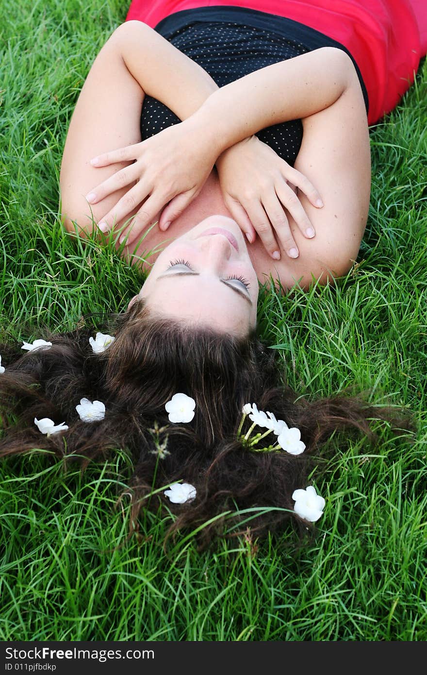 Portrait of a beautiful young woman with flowers in her hair.