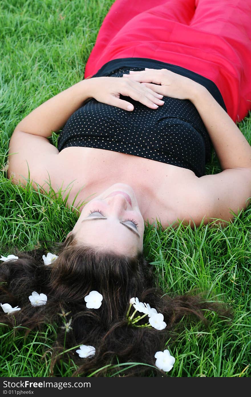 Portrait of a beautiful young woman with flowers in her hair.