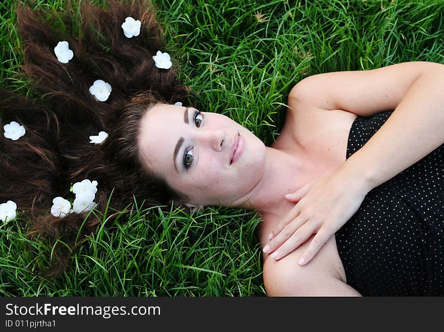 Portrait of a beautiful young woman with flowers in her hair.