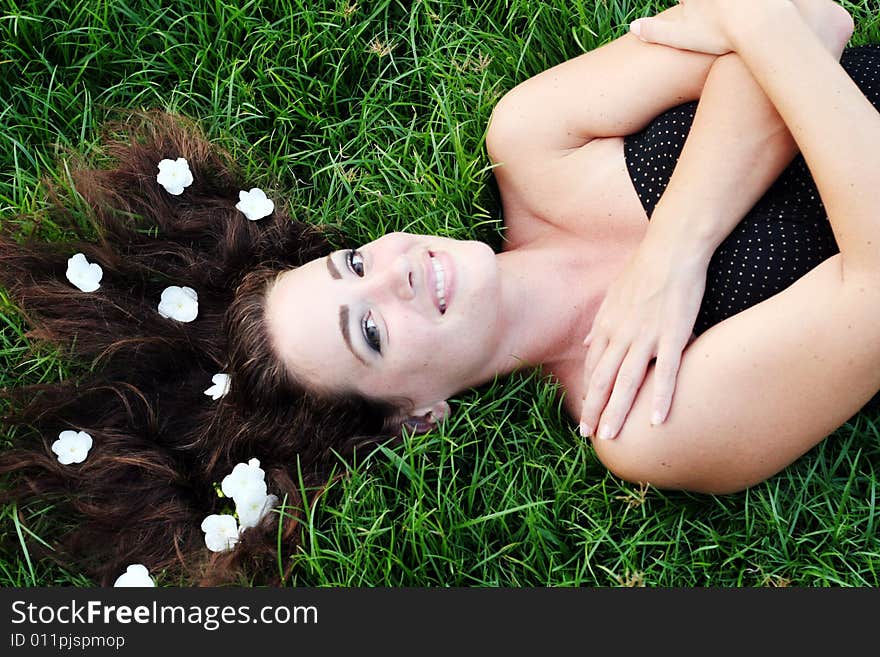 Portrait of a beautiful young woman with flowers in her hair.