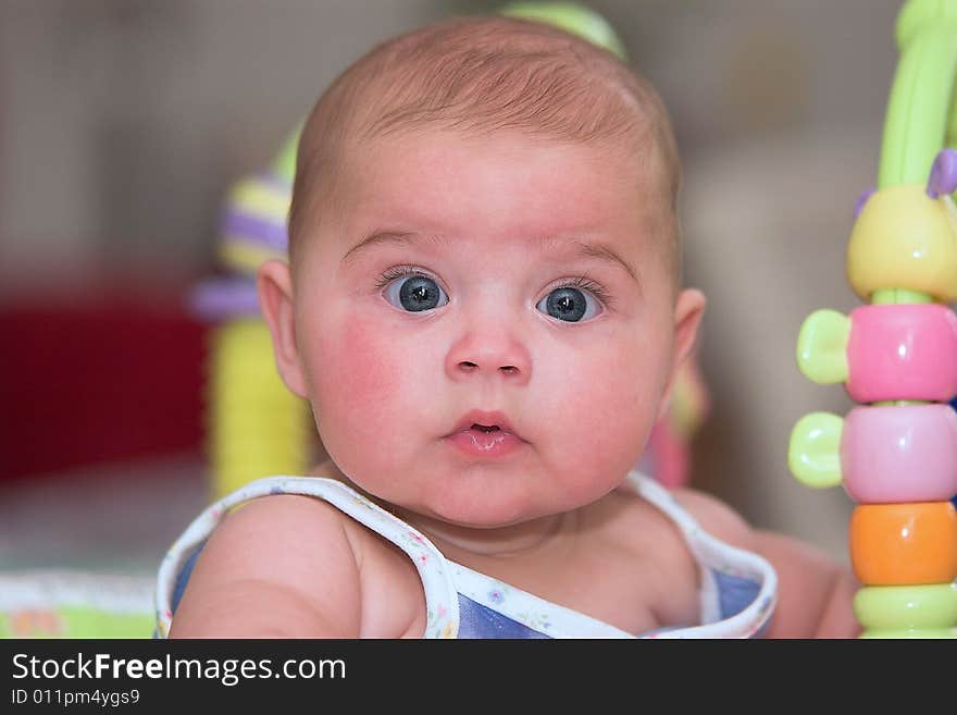 A baby girl very wide-eyed and attentive. A baby girl very wide-eyed and attentive