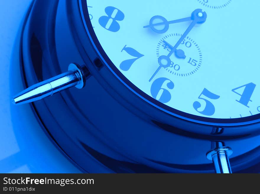 Close-up image of a clock face - blue tint. Close-up image of a clock face - blue tint.