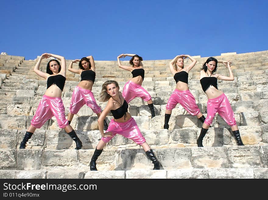 Beautiful modern dancers on the ancient stairs of  Kurion amphitheatre in Cyprus.