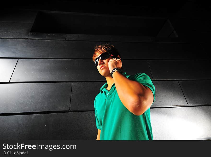 Picture of a male model with technology related activities and a dark background. Use for illustrating contexts of IT, suaveness or computer crimes. Series contains different expressions. Picture of a male model with technology related activities and a dark background. Use for illustrating contexts of IT, suaveness or computer crimes. Series contains different expressions.