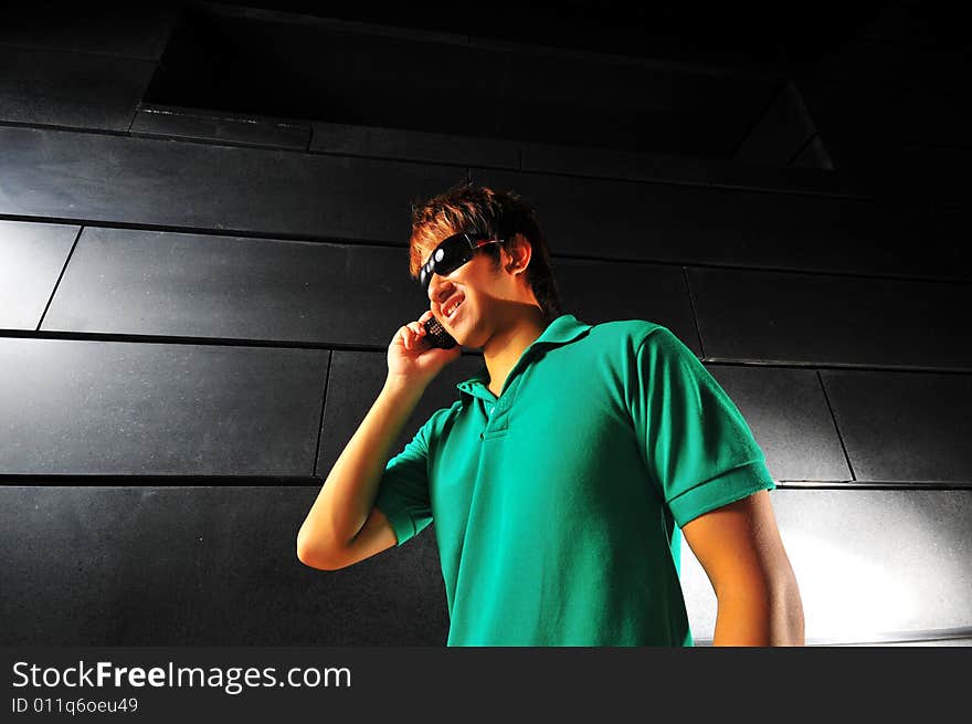 Picture of a male model with technology related activities and a dark background. Use for illustrating contexts of IT, suaveness or computer crimes. Series contains different expressions. Picture of a male model with technology related activities and a dark background. Use for illustrating contexts of IT, suaveness or computer crimes. Series contains different expressions.