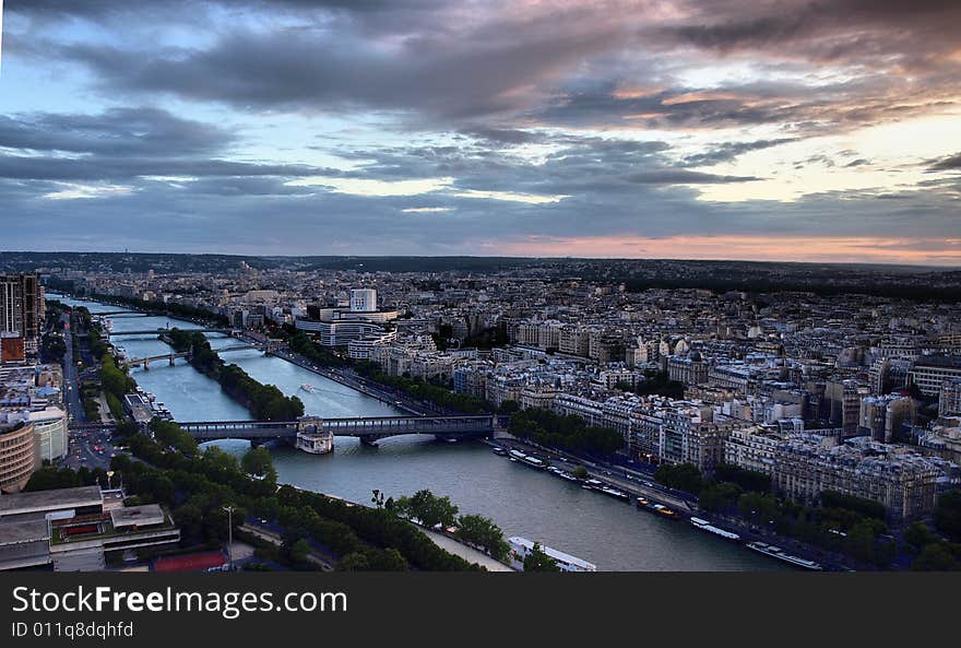 This is a sunset photo of the Paris Cityscape and Seine River from the Eiffel Tower