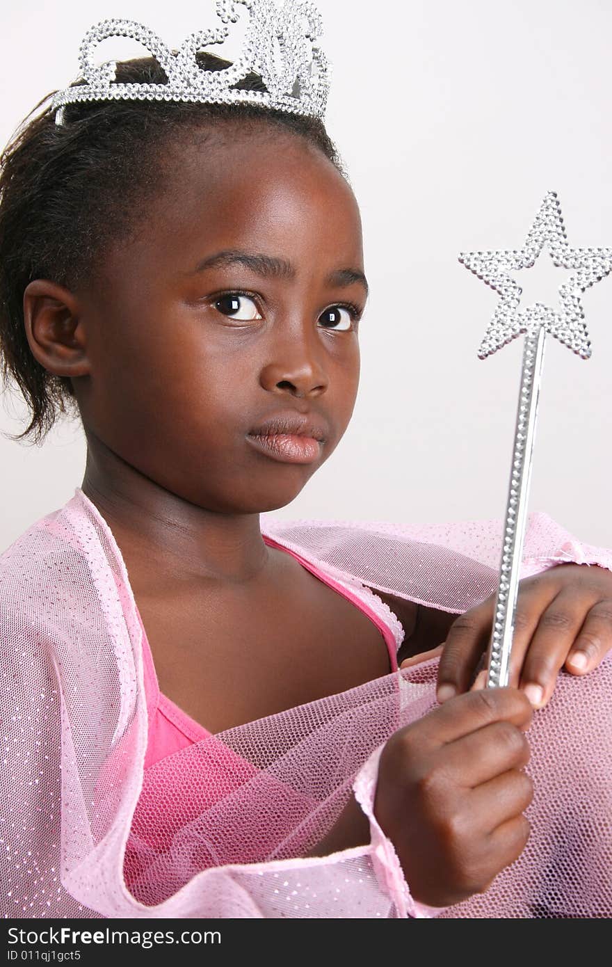 Young girl wearing a pink fairy costume with accessories