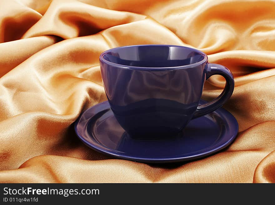 Cup and saucer on fabric