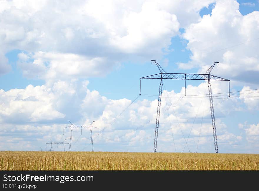 Electrical powerlines with blue sky and white clouds