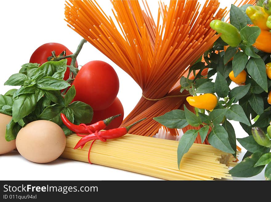 Bunch of spaghetti, tomatoes, basil and sweet baby pepper isolated on white background. Bunch of spaghetti, tomatoes, basil and sweet baby pepper isolated on white background