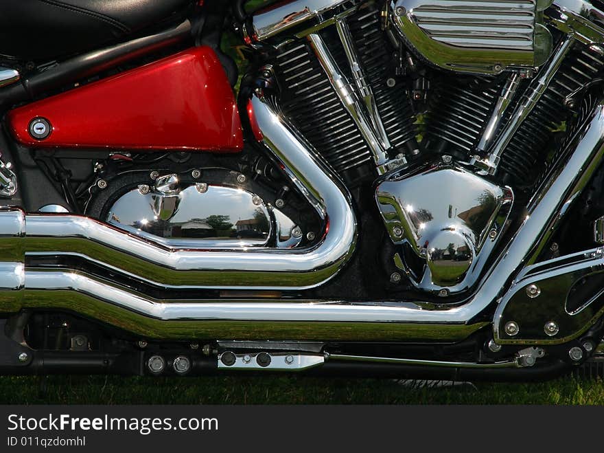 Close-up of a side and motor motorcycle with chrome shiny details. Close-up of a side and motor motorcycle with chrome shiny details.