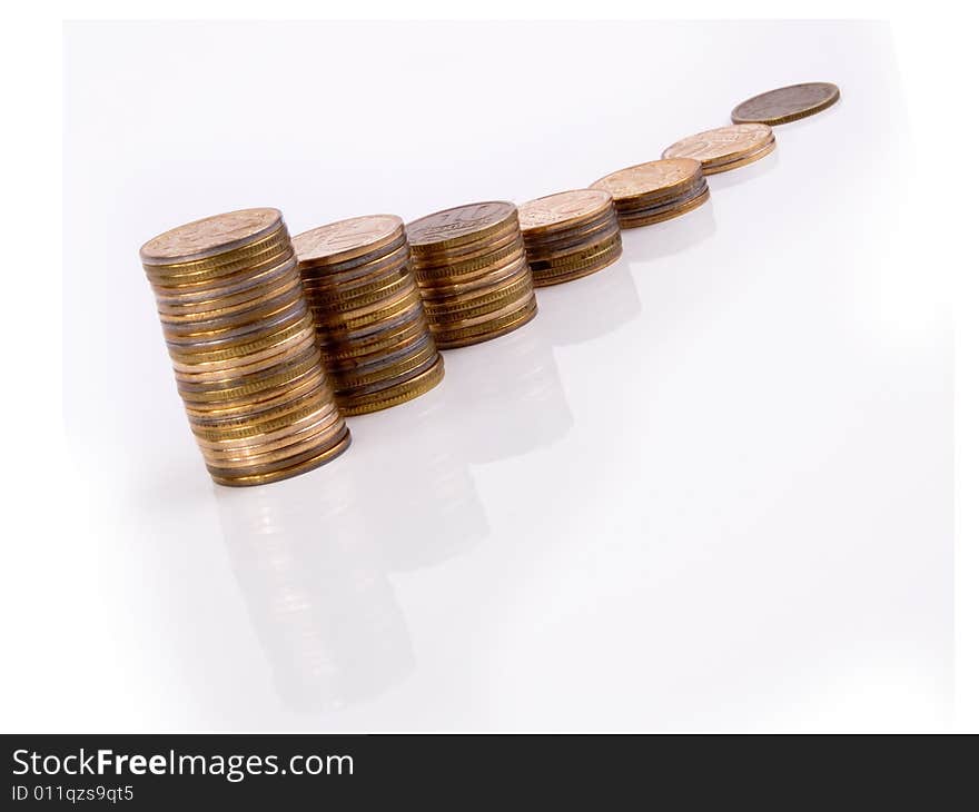 Growing stacks of coins with reflections on a white backround. Growing stacks of coins with reflections on a white backround